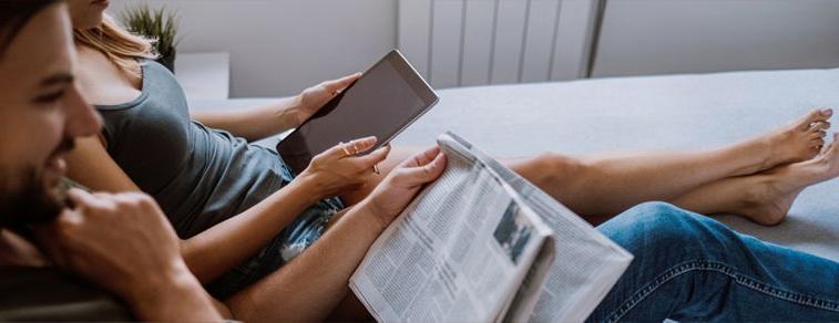 A couple reads on the couch.